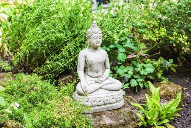 Small Meditating Buddha statue on plinth